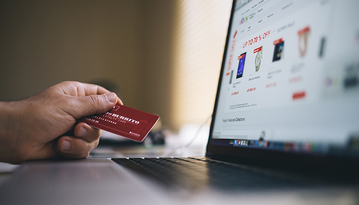 online shopper with credit card in hand