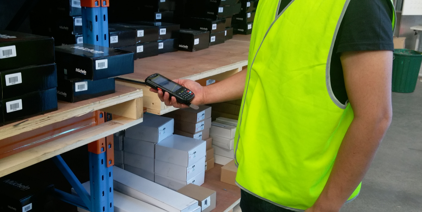 warehouse employee updating inventory with scanner