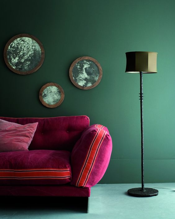 Furniture photography image of red sofa with wall mirrors and lamp to show scale