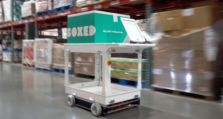 Boxed Wholesale's new green and gray self-driving vehicle cart for their warehouses